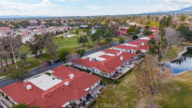 drone / aerial view with a water and mountain view