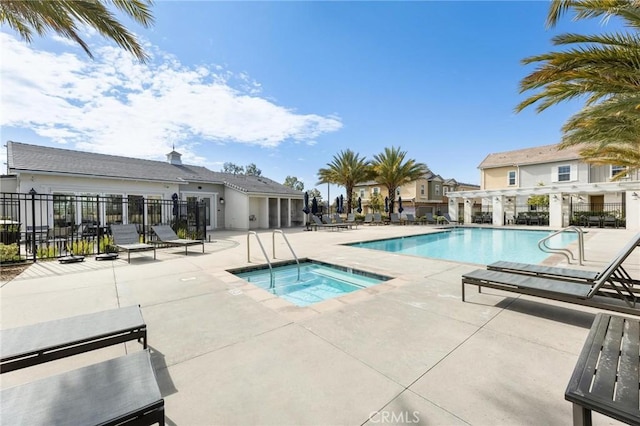 view of pool with a hot tub and a patio area