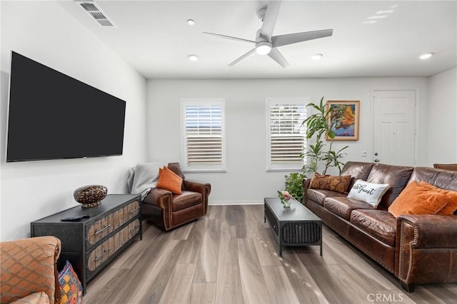 living room featuring ceiling fan and light wood-type flooring