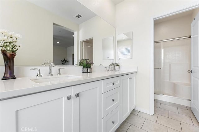 bathroom featuring vanity, tile patterned floors, and walk in shower