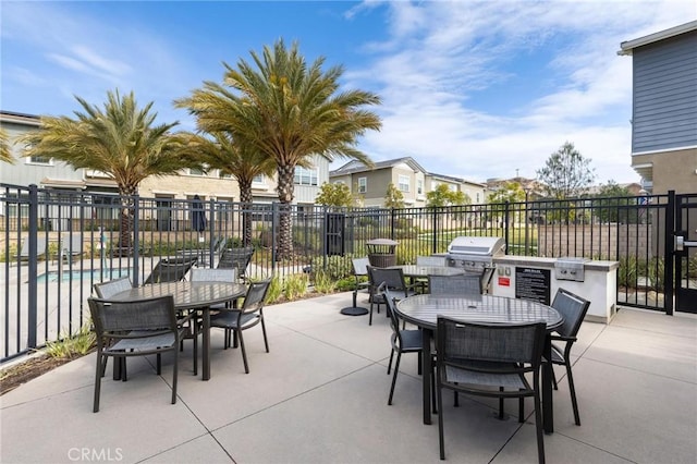 view of patio / terrace featuring a community pool and grilling area