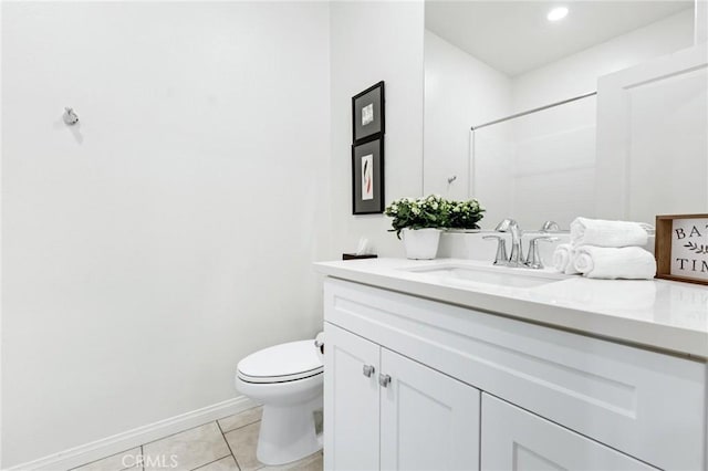 bathroom with tile patterned floors, toilet, vanity, and a shower