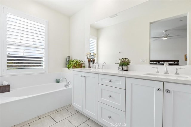 bathroom with tile patterned flooring, vanity, a washtub, and ceiling fan