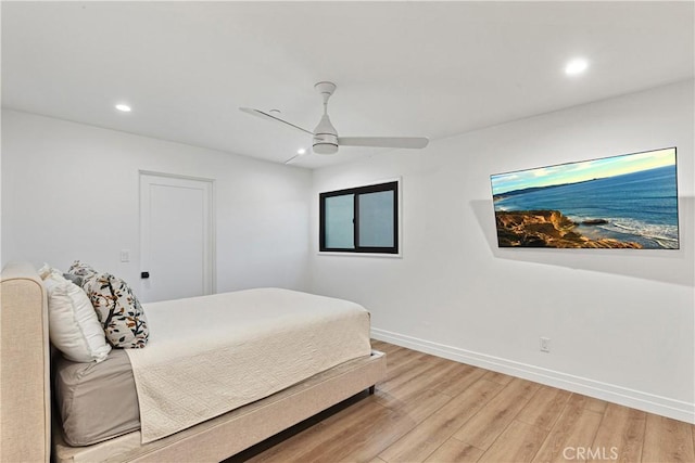 bedroom featuring light hardwood / wood-style floors and ceiling fan