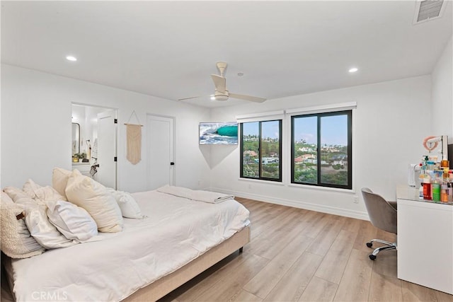 bedroom featuring light hardwood / wood-style floors and ceiling fan