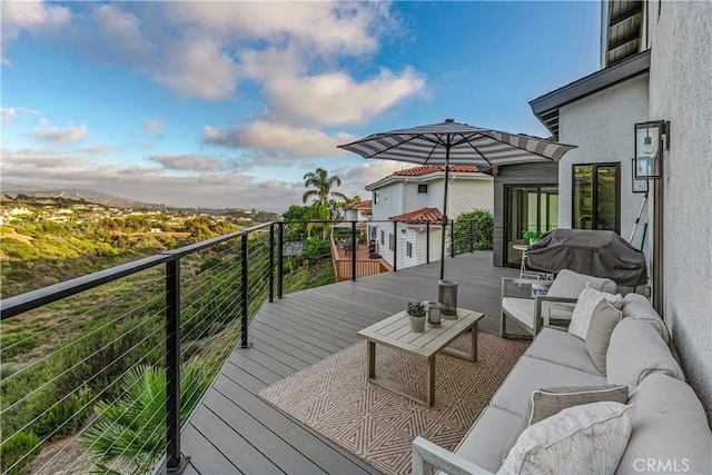 deck featuring a grill and outdoor lounge area