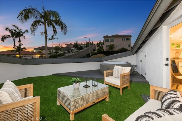 yard at dusk featuring outdoor lounge area and a patio