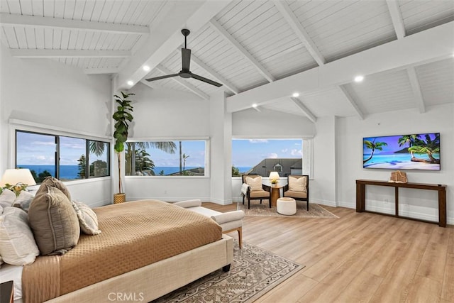 bedroom featuring beam ceiling, high vaulted ceiling, baseboards, and wood finished floors