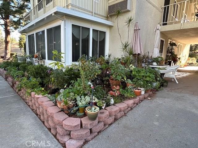 view of side of home with a balcony