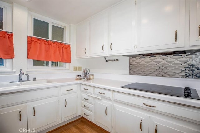 465 Avenida Sevilla Unit C, Laguna Woods, CA 92637 - kitchen with a sink, white cabinetry, tasteful backsplash, and light countertops