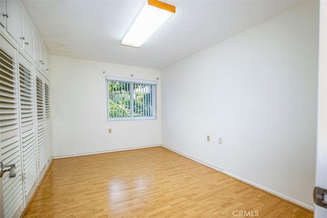 465 Avenida Sevilla Unit C, Laguna Woods, CA 92637 - unfurnished bedroom featuring light wood-style flooring, baseboards, and a closet