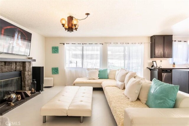 living room with a textured ceiling and a fireplace