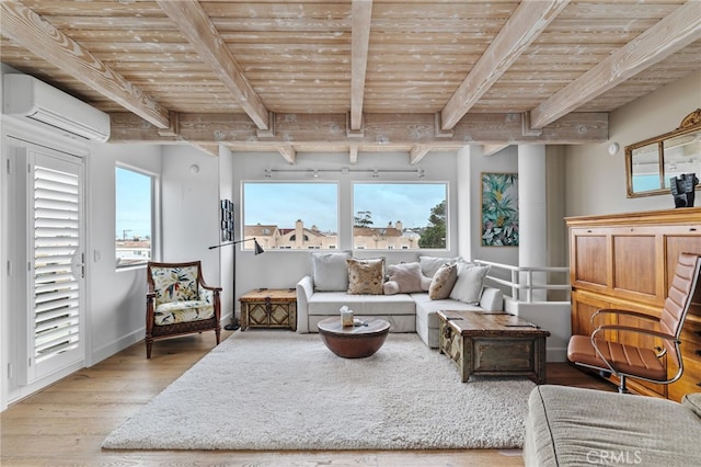 sitting room with light hardwood / wood-style floors, wooden ceiling, an AC wall unit, and beamed ceiling