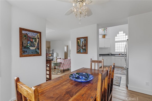 dining area with ceiling fan and light wood-type flooring