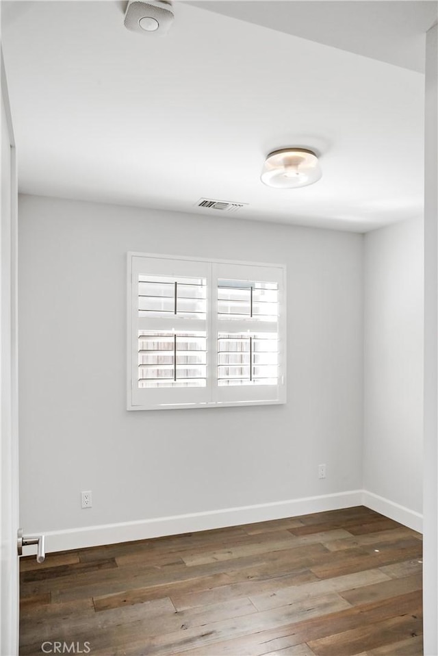 unfurnished room featuring dark hardwood / wood-style floors