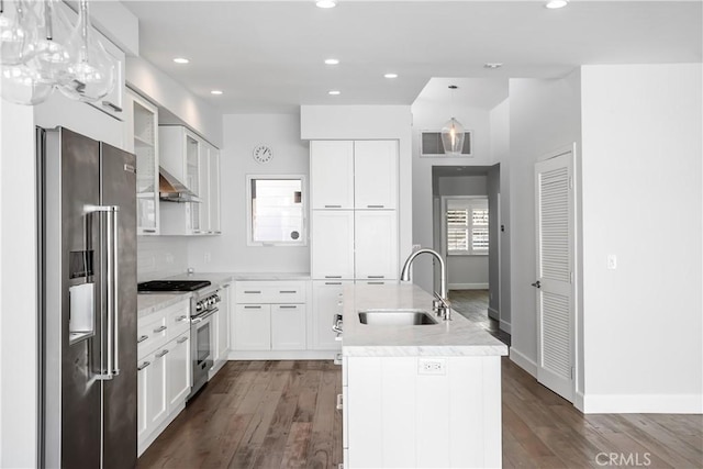 kitchen featuring white cabinets, decorative light fixtures, sink, and high quality appliances