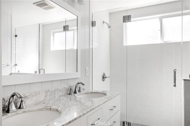 bathroom featuring walk in shower and vanity