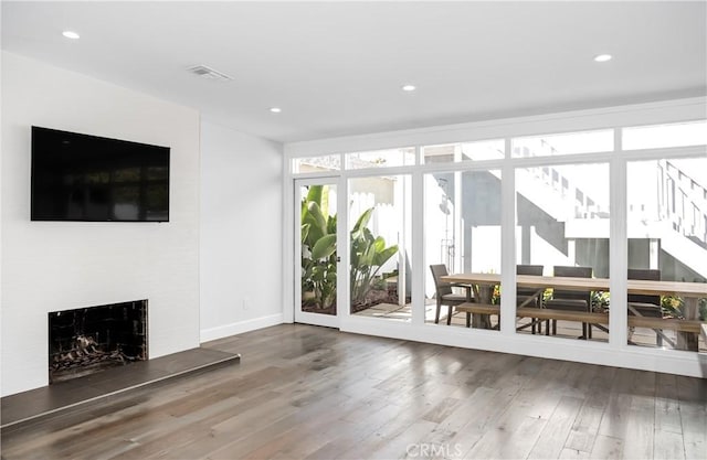 unfurnished living room with wood-type flooring