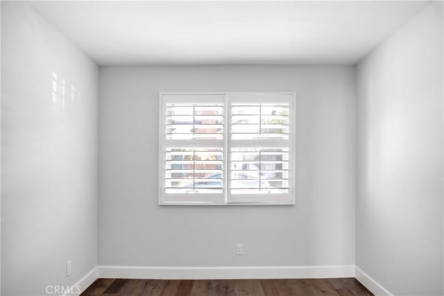 empty room with dark hardwood / wood-style floors