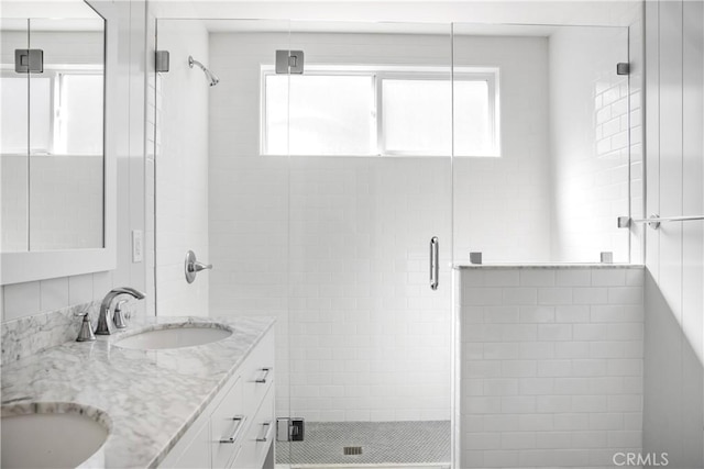 bathroom featuring vanity and a shower with shower door