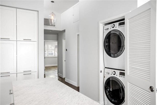 laundry area featuring stacked washer and dryer