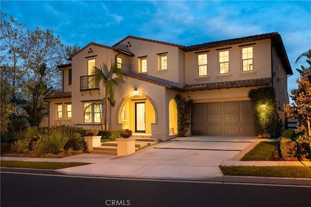 mediterranean / spanish-style house with a garage