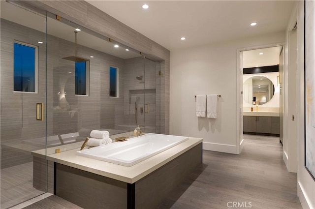 bathroom featuring vanity, hardwood / wood-style floors, and a shower with shower door