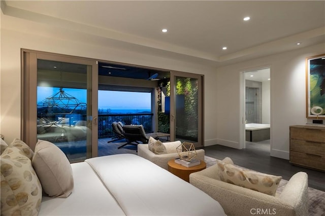 bedroom with ensuite bathroom and dark hardwood / wood-style floors