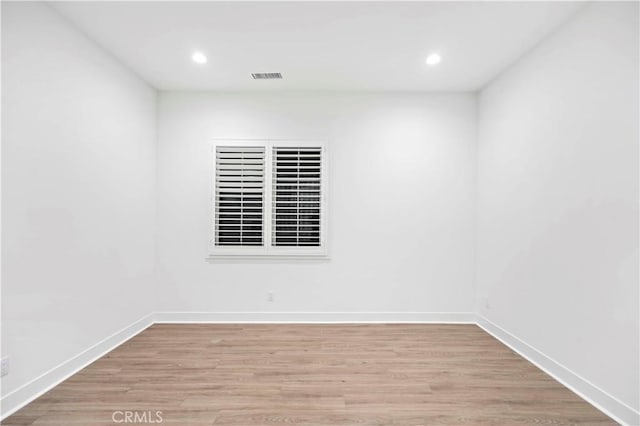 spare room featuring light wood-type flooring