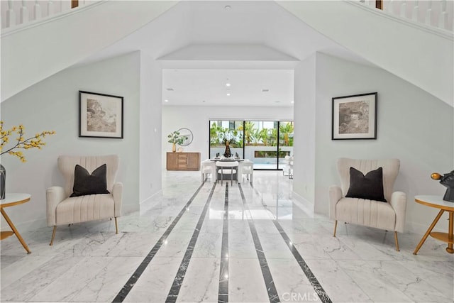 sitting room featuring high vaulted ceiling