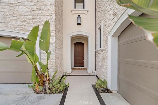 view of exterior entry featuring a garage