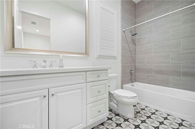 full bathroom with vanity, toilet, and tiled shower / bath combo