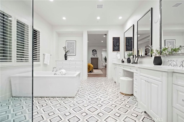 bathroom with vanity and a tub to relax in