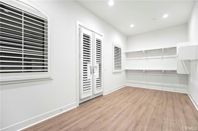 walk in closet with light wood-type flooring