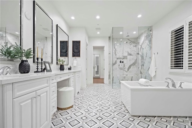 bathroom featuring shower with separate bathtub and vanity