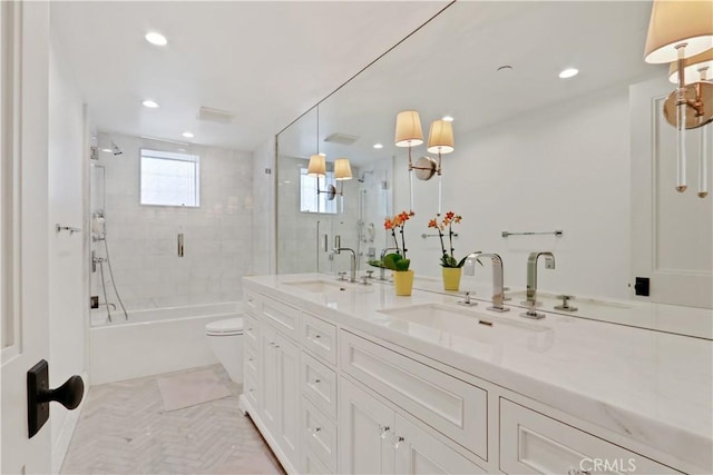 bathroom with double vanity, recessed lighting, and a sink