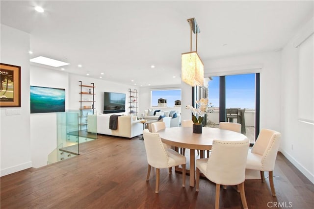 dining space featuring recessed lighting, wood finished floors, and baseboards