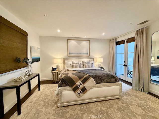 bedroom featuring visible vents, wood finished floors, recessed lighting, baseboards, and access to exterior