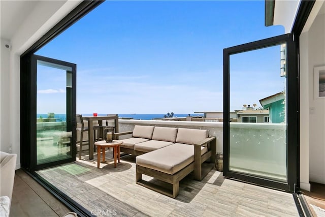 balcony featuring an outdoor hangout area and a water view