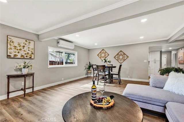 living room featuring hardwood / wood-style flooring, ornamental molding, and a wall unit AC