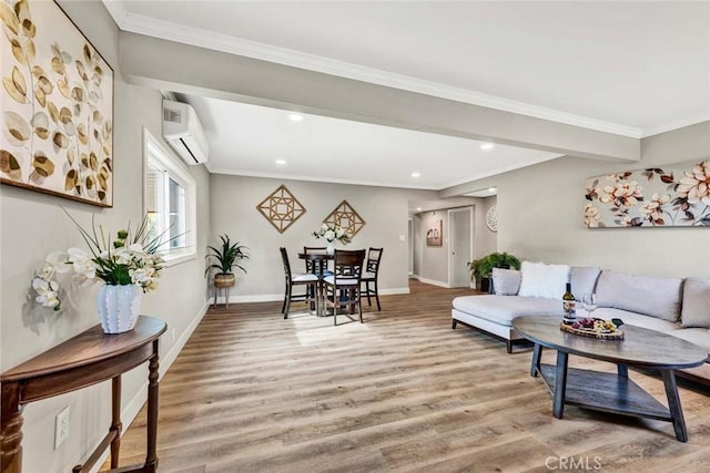 living room with crown molding, wood-type flooring, and a wall unit AC