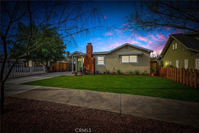 view of front of home with a yard