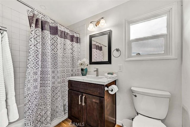 full bathroom with vanity, shower / bathtub combination with curtain, and toilet