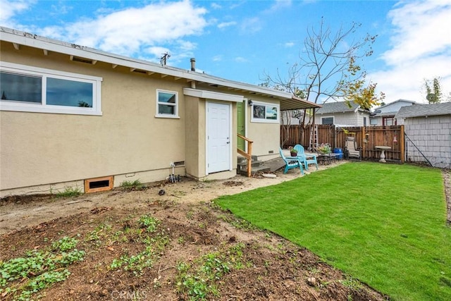 rear view of property featuring a yard