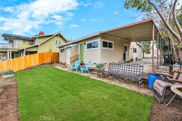 rear view of property with a yard