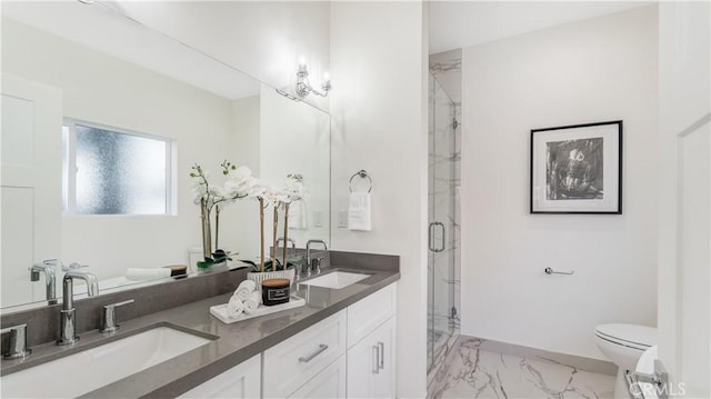 bathroom featuring vanity, toilet, and a shower with shower door