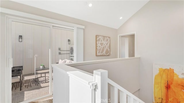 hallway featuring hardwood / wood-style flooring and vaulted ceiling