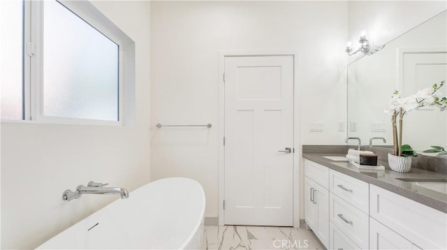 bathroom with vanity and a tub