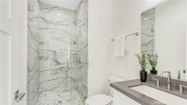 bathroom with vanity, toilet, and an enclosed shower