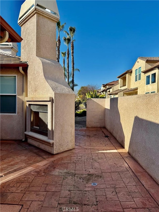 view of patio featuring an outdoor fireplace